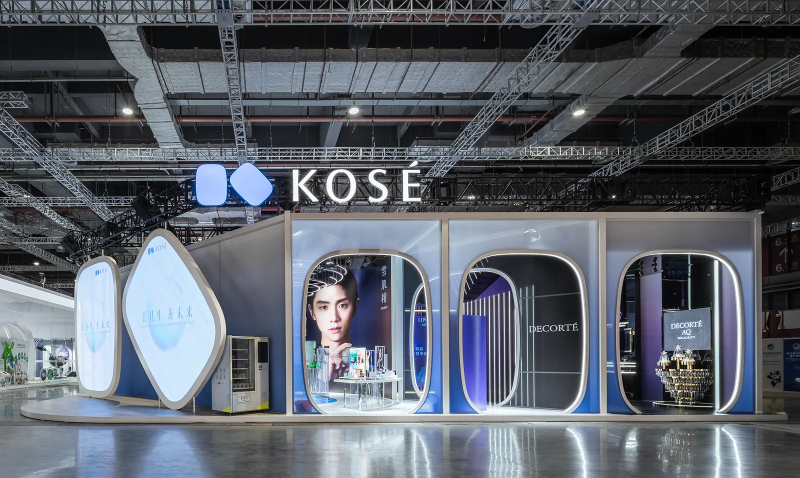 KOSÉ exhibition stand with illuminated blue branding and arched product zones at CIIE in Shanghai.
