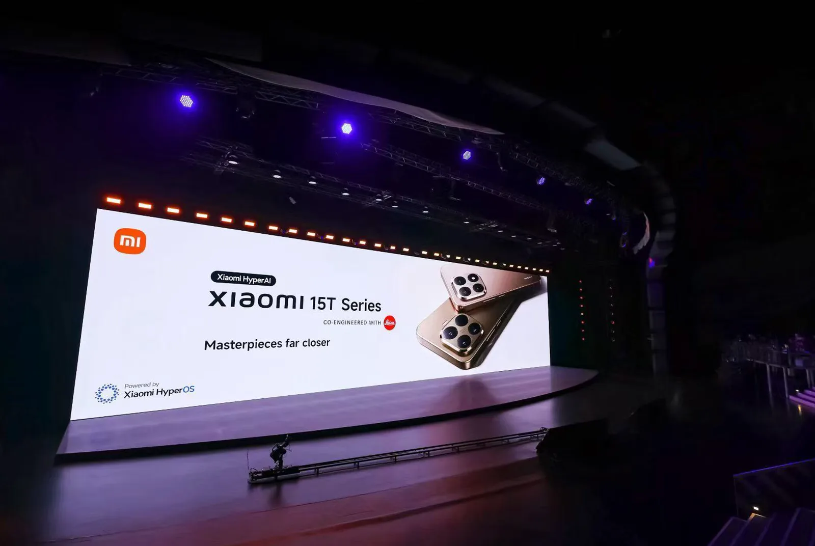 Xiaomi launch stage with a large presentation screen above a darkened auditorium.