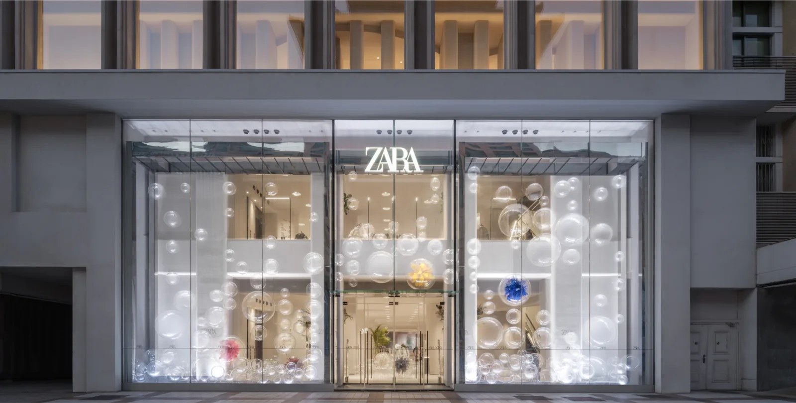 ZARA store façade with illuminated window installation in Shanghai.